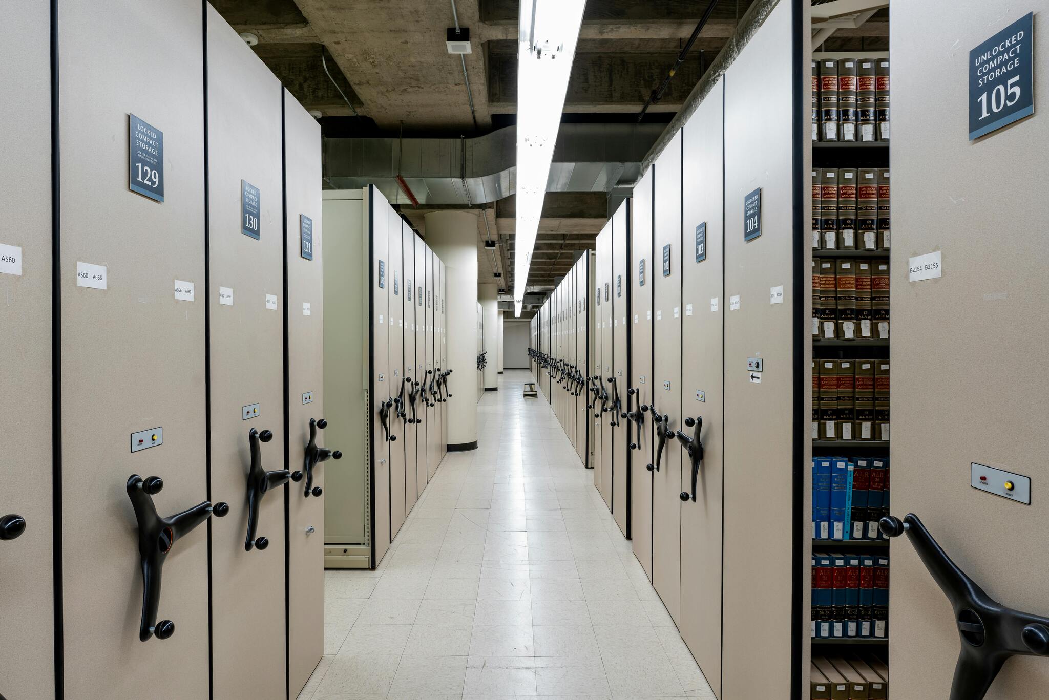 Numbered compliance folders on a shelf, representing dossier structure for a FINMA application
